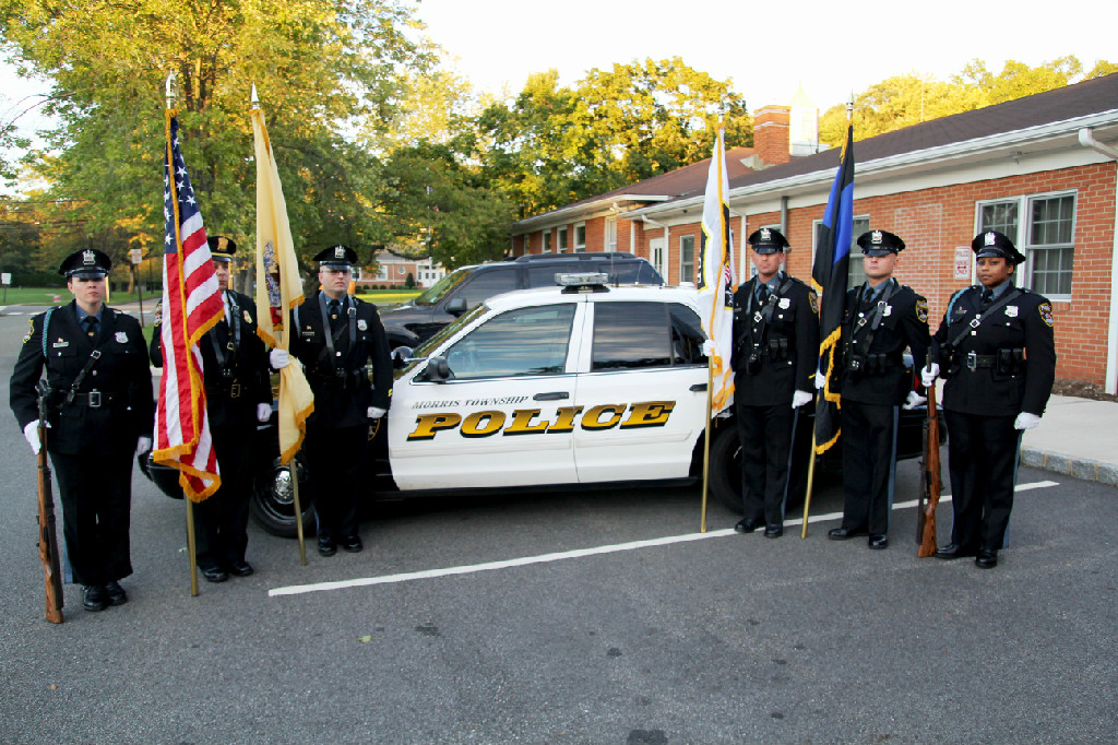 Honor Guard posing with a police cruiser. 